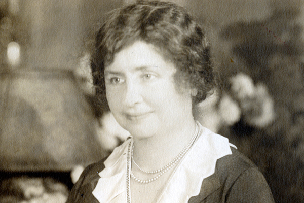 Helen Keller, wearing a double-stranded pearl necklace.