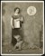 Thumbnail of Photograph of Helen Keller standing indoors with a large dog (Sie...