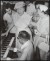 Thumbnail of Photograph taken indoors of Helen Keller sensing the vibrations o...