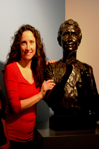 AFB Archivist Helen Selsdon standing next to Helen Keller bust