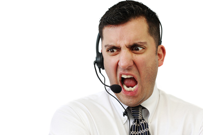 A customer service agent yells angrily into his headset.