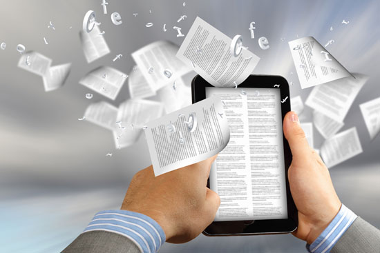 A man holds an e-reader with text pages flying out of the screen.