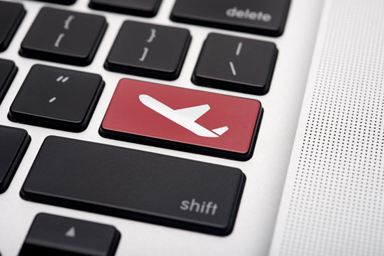 'Online flight booking' icon button of a computer keyboard.