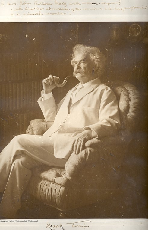 This full-length photographic portrait of Samuel Langhorne Clemens (Mark Twain) shows him sitting in an armchair smoking a pipe, 1909. Clemens inscribed the photograph with the following: "To Mrs. John Sullivan Macy with warm regard & with limitless admiration of the wonders she has performed as a miracle-worker."