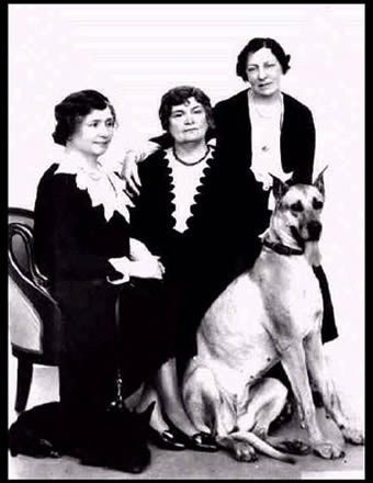 This picture shows Helen Keller, Anne Sullivan Macy, and Polly Thomson, with dogs Darky and Helga, circa 1931. 