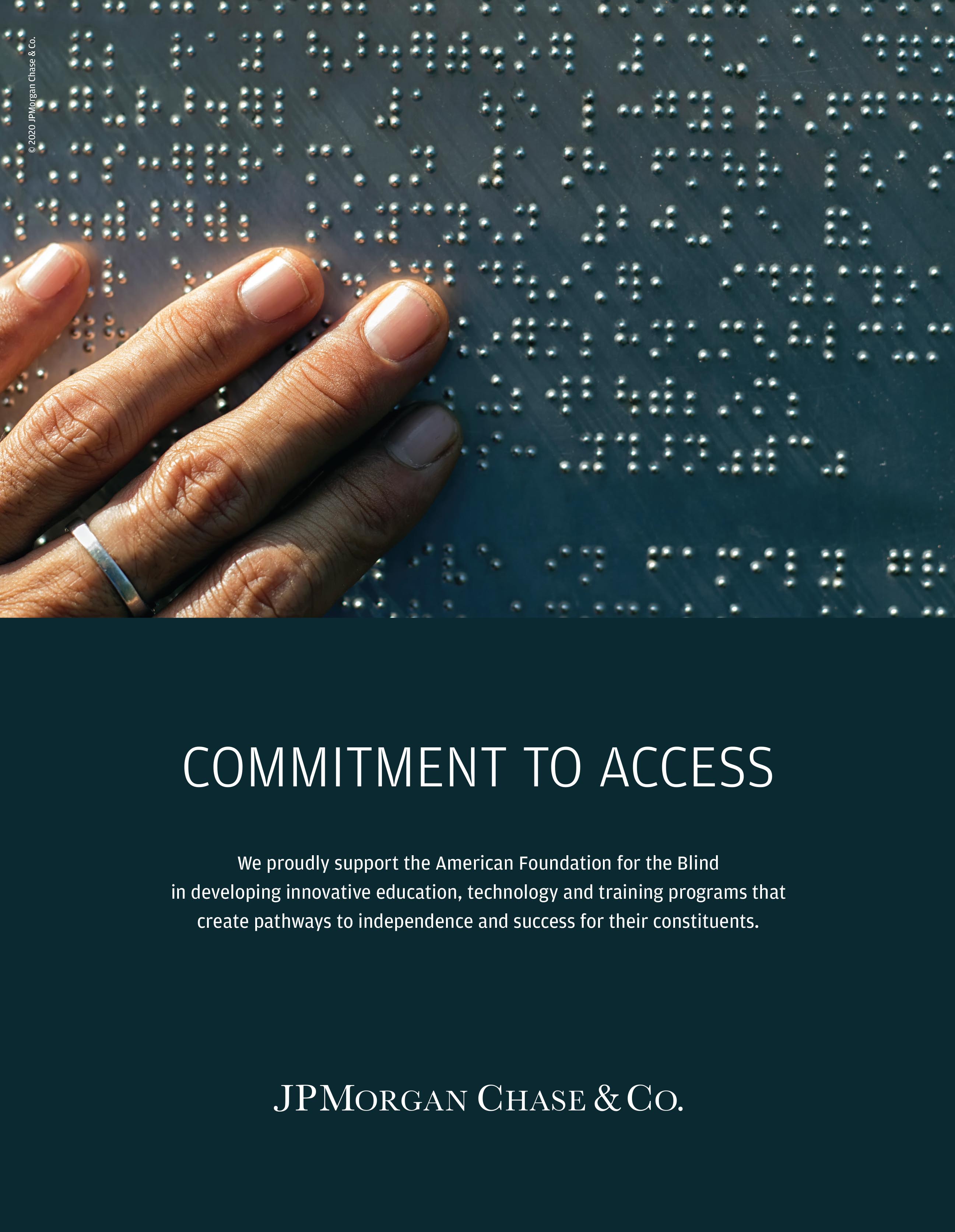 Image: Tight close-up of a brown-skinned hand with narrow silver ring on the middle finger touching a page of braille.