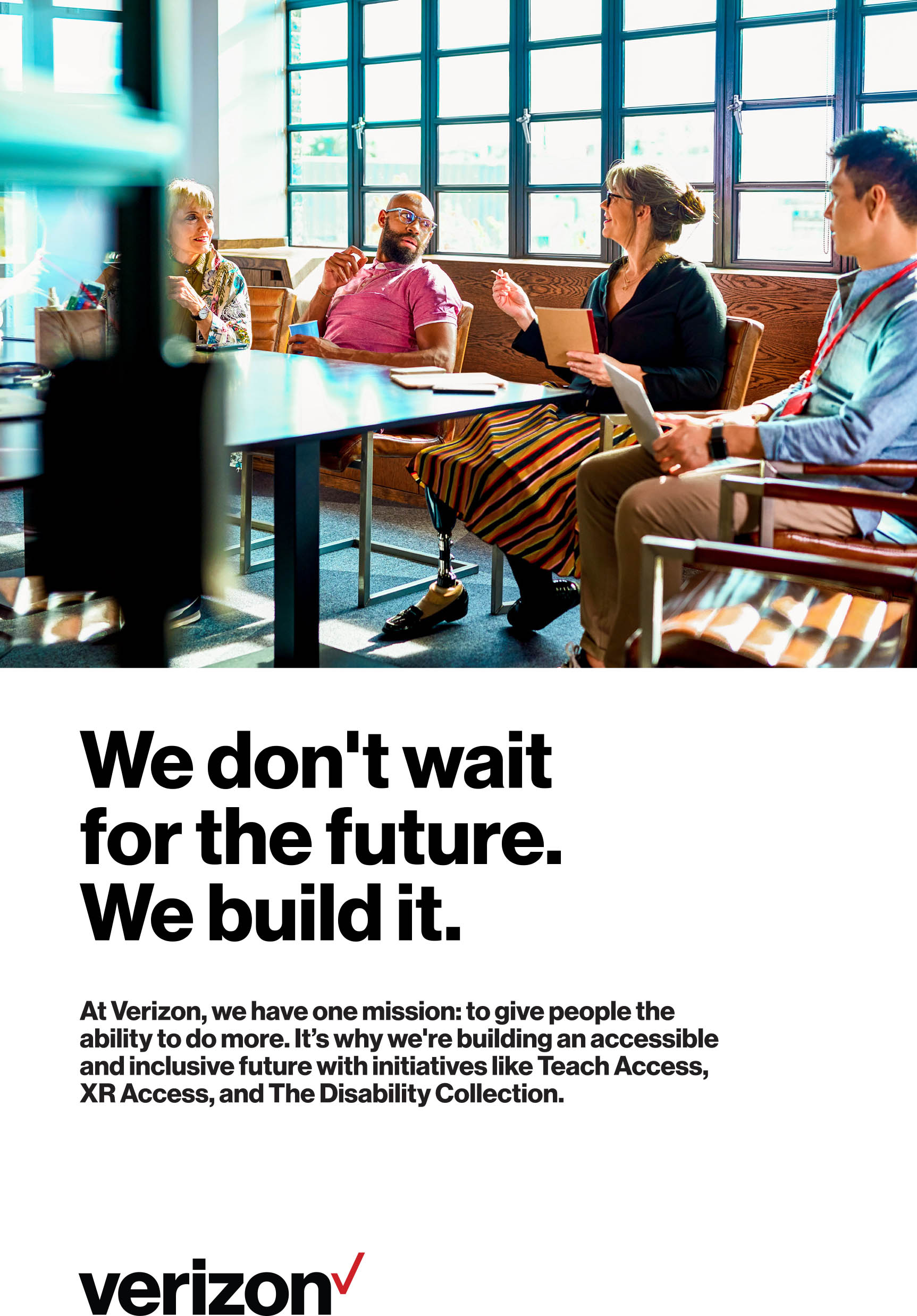 Image: A diverse group of people meeting at a table in a sunlit office space. 