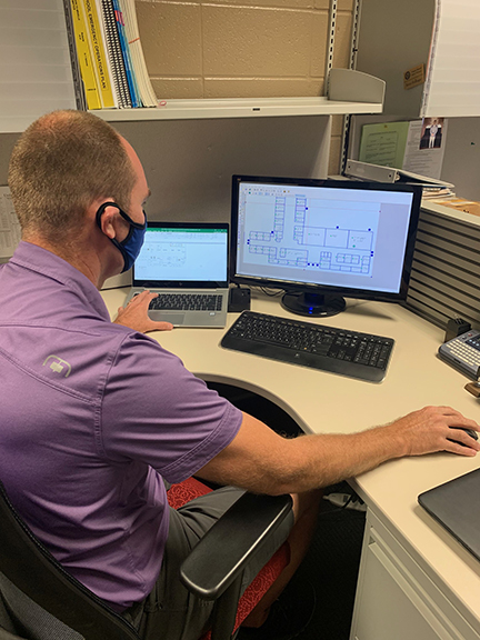A White O&M specialist uses a computer program to design a map for a braille reader. 