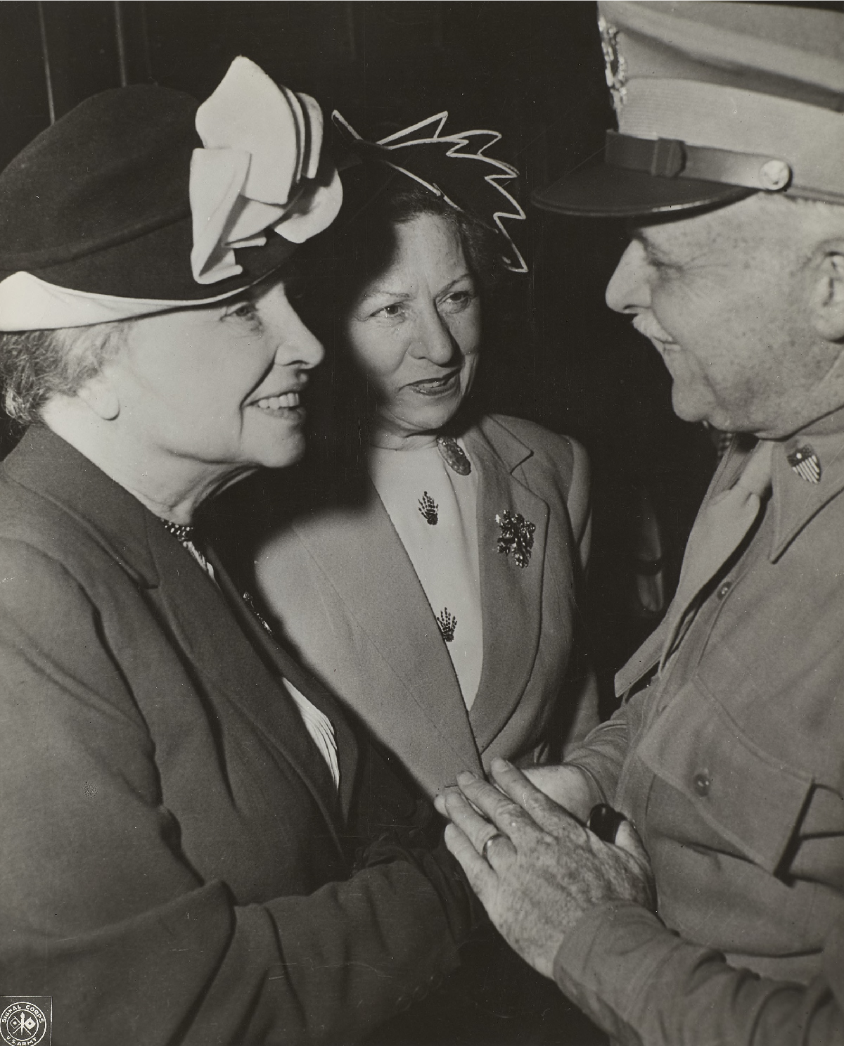 Helen Keller and Polly Thomson shake hands with Colonel Harbison in Tokyo.