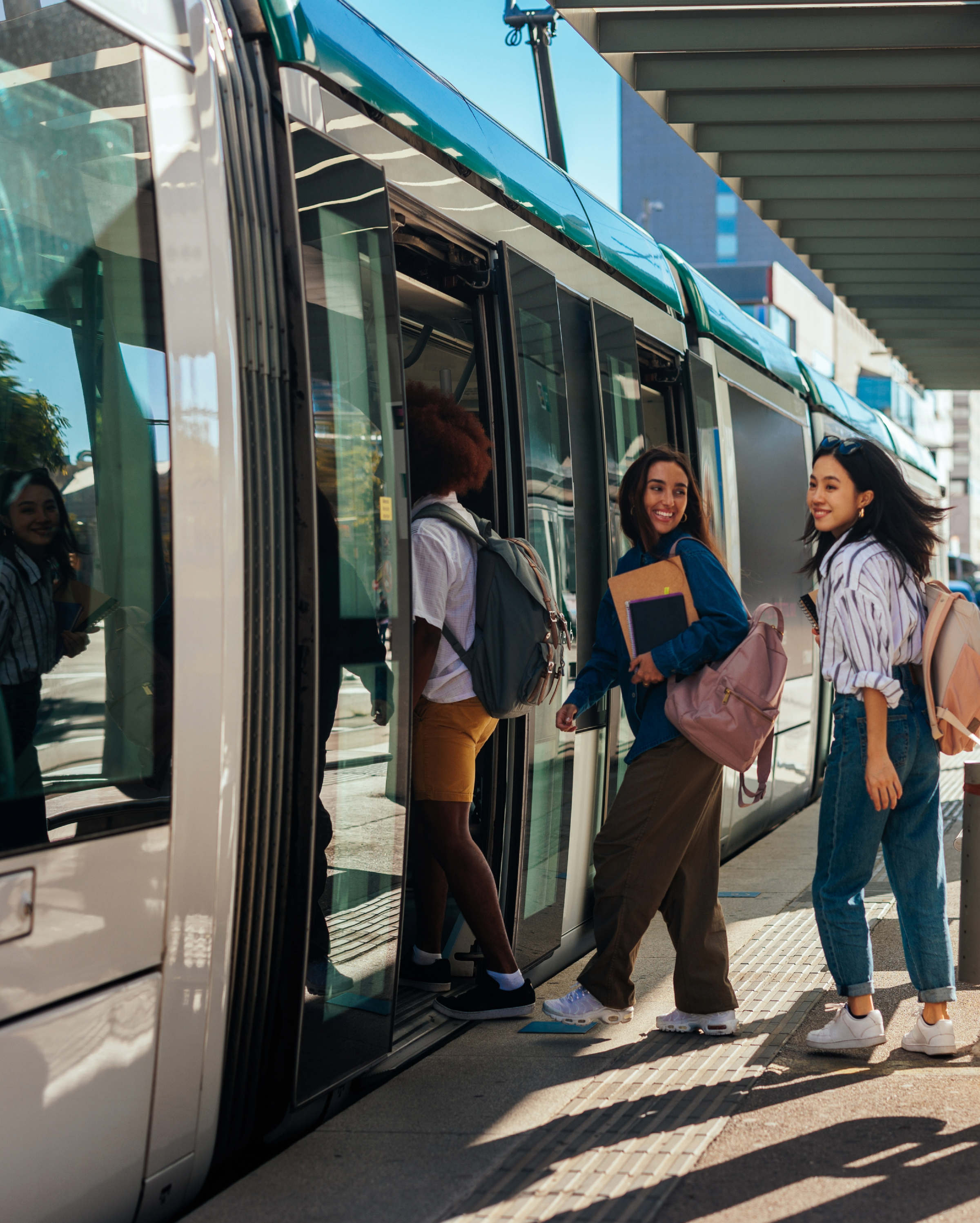 Passengers board a subway train at a station.