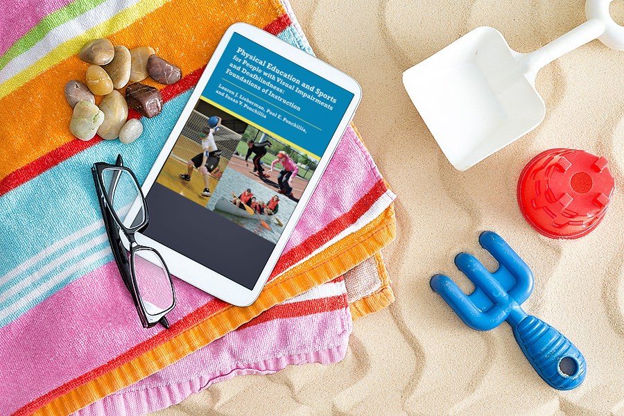 beach towel with an iPad on it displaying AFB Press's Physical Education and Sports ebook
