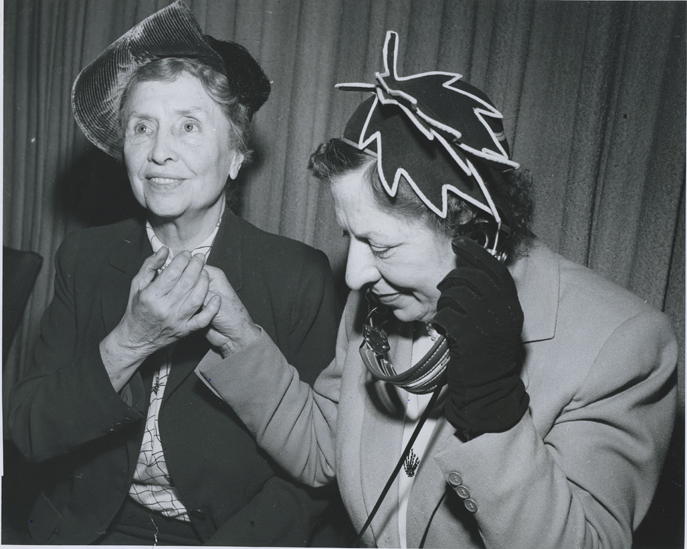 Helen Keller is 'listening' to a debate at the United Nations. Keller's companion Polly Thomson manually signs into Keller's hand, interpreting the debate, November 1949