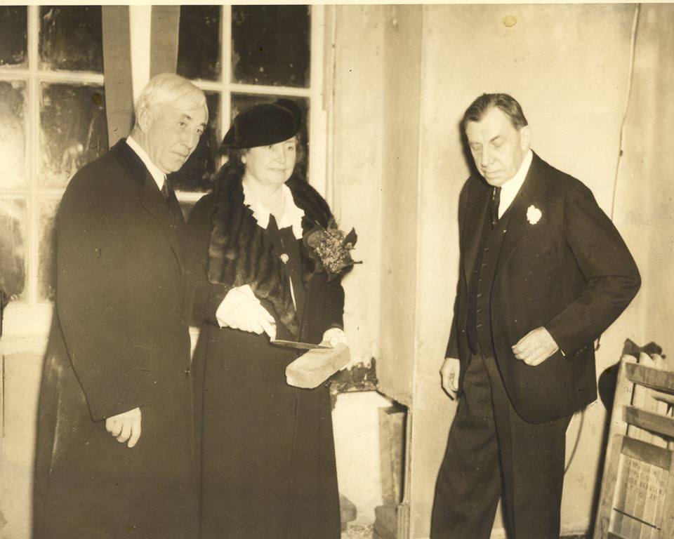 M. C. Migel, Helen Keller, and John Finley at the cornerstone-laying for the American Foundation for the Blind's building on 16th Street in Manhattan, NYC, 1934. Helen is holding a brick and trowel
