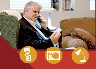 man looking at med bottle, talking on phone, using a task lamp