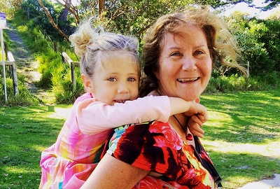 older woman with granddaughter playing piggyback