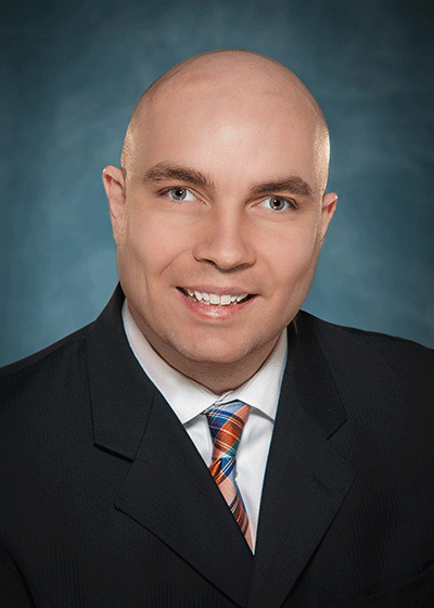 headshot of Russell Shaffer, wearing a suit and tie