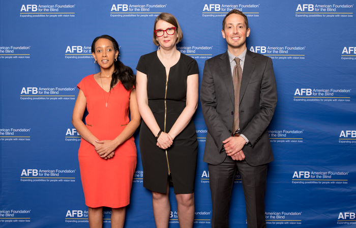Haben Girma, Jenny Lay-Flurrie, and Jeff Wieland stand in front of a blue background with the AFB Logo.