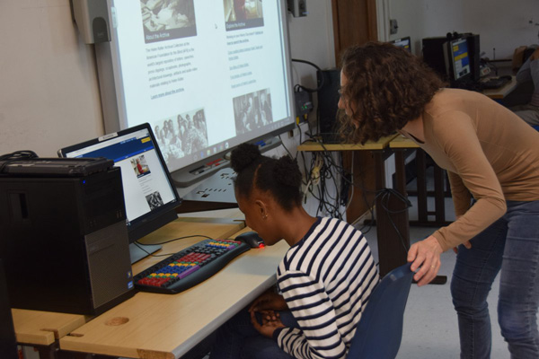 Helen Selsdon at NYISE helping a student explore the Helen Keller Archive