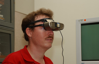 Figure 3: Paul Mogan wearing the Jordy, a head-mounted device that resembles binoculars. 
