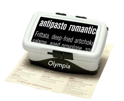 Photo of the Olympia CCTV sitting on a menu. The large, rectangular screen shows part of the menu ("antipasto romantico") displayed in large type in reverse polarity.