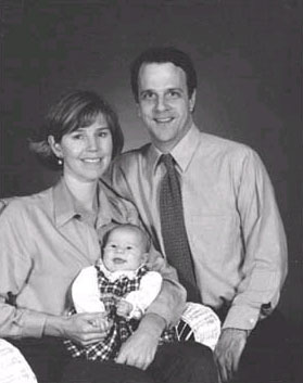 Photo of Doug Geoffray with his wife and baby.