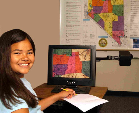 A student viewing a colorful map using her Clarity DeskMate.