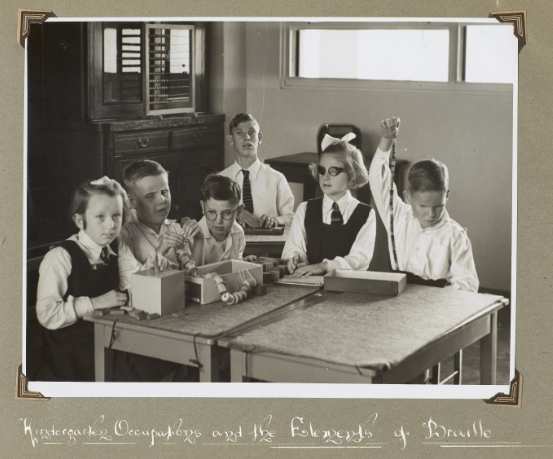 Photograph of students playing and learning in a kindergarten class at a school for students who are blind, Australia. 1948