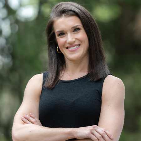 Rebecca Alexander, smiling, her arms crossed.