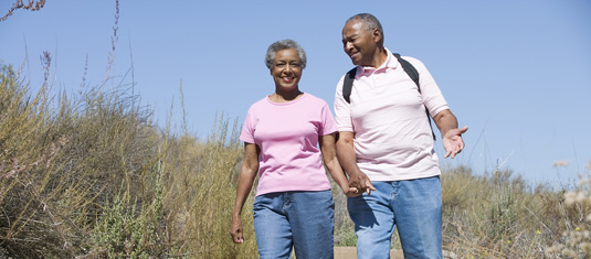 senior couple walking on the beach