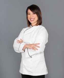 Christina Ha standing with arms folded wearing a white chef's tunic and black pants; Courtesy of Julie Soefer Photography.